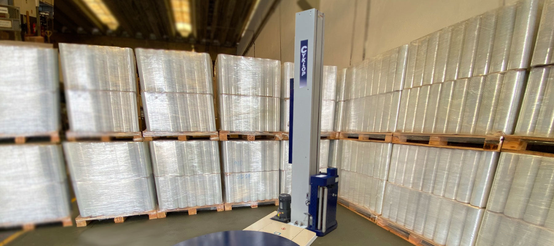 Industrial wrapping machine with wrapped items.
